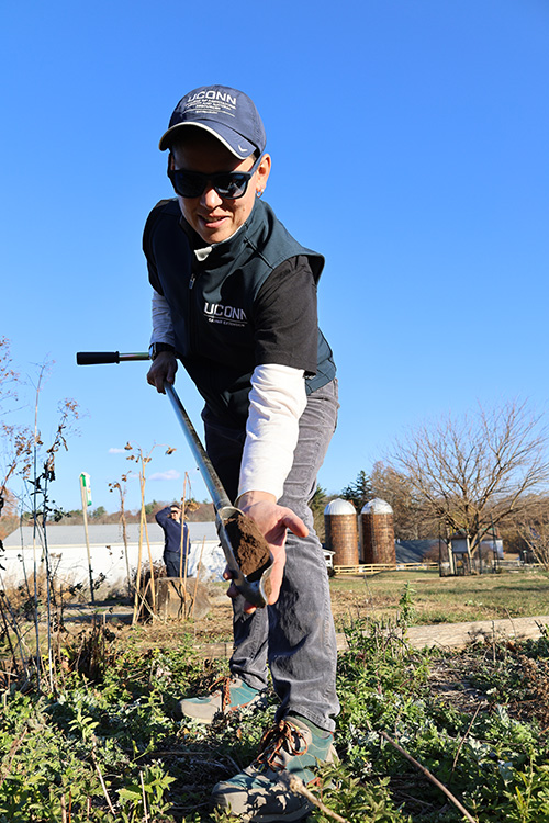 Amelia Magistrali taking a soil sample